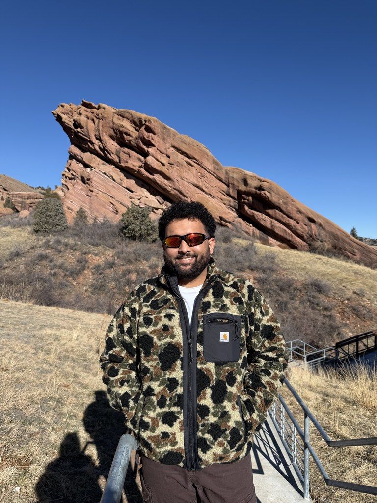 Tanmay in front of the Red Rocks formation in Colorado