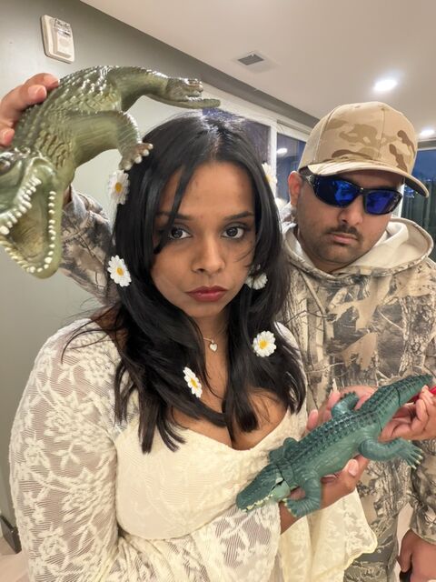 In costume, holding toy alligators